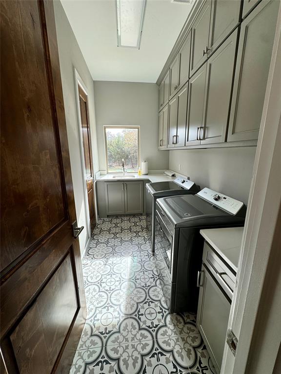 474 Eagle Cove Circle Tioga, TX 76271 - Photo 18 of 26 a utility room with cabinets washer and dryer