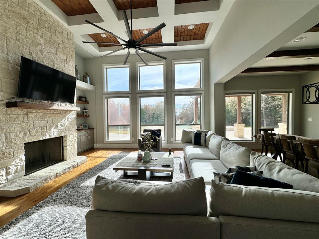 474 Eagle Cove Circle Tioga, TX 76271 - Photo 2 of 26 a living room with furniture a fireplace and a flat screen tv