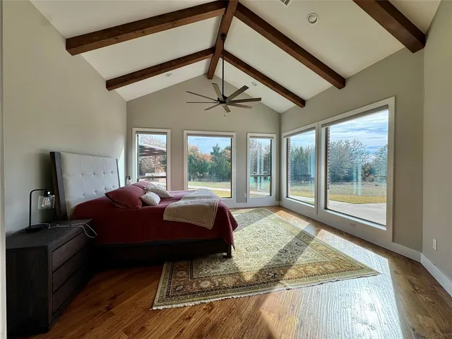 a living room with a bed furniture and a large window