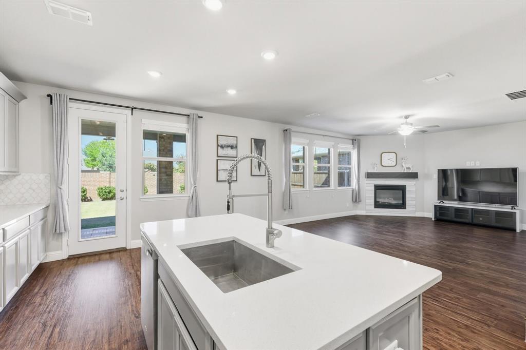 4125 Caprock Canyon Road Sachse, TX 75048 - Photo 39 of 40 a kitchen with a stove a sink and a refrigerator