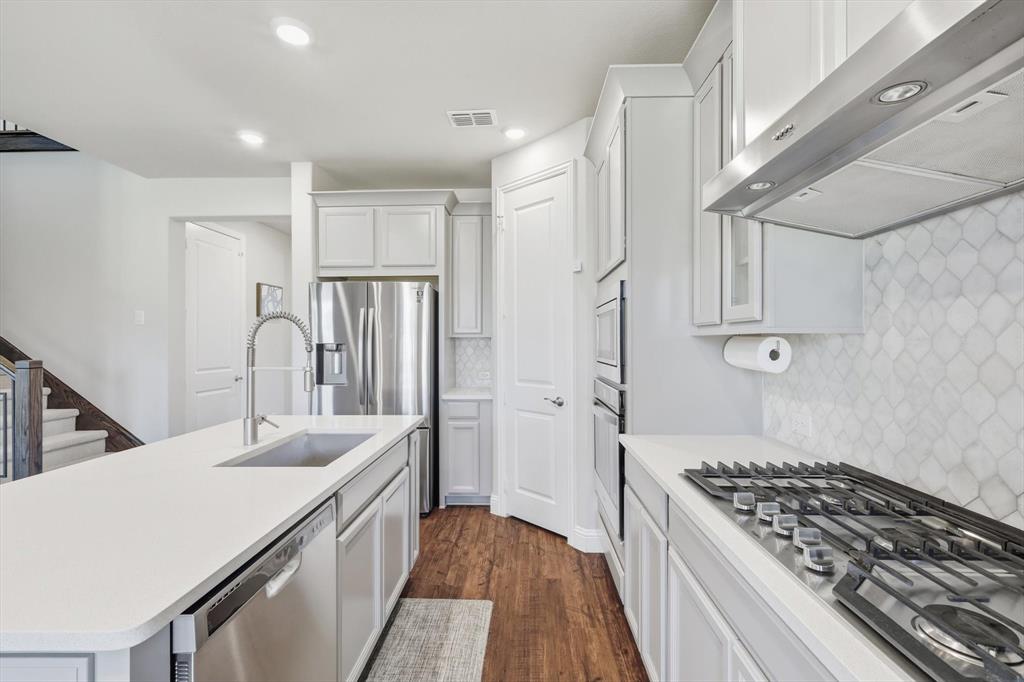 4125 Caprock Canyon Road Sachse, TX 75048 - Photo 14 of 40 a kitchen with a sink stove and refrigerator