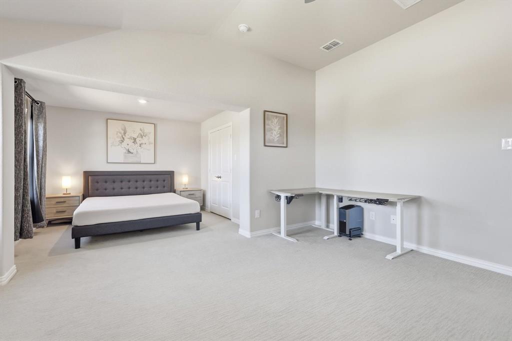 4125 Caprock Canyon Road Sachse, TX 75048 - Photo 15 of 40 a spacious bedroom with a bed and a couch