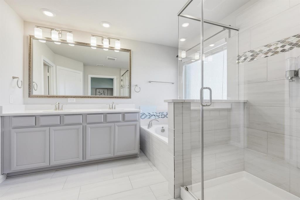 4125 Caprock Canyon Road Sachse, TX 75048 - Photo 18 of 40 a spacious bathroom with a shower a sink and mirror