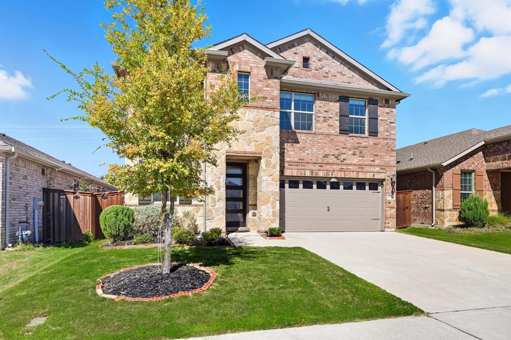 4125 Caprock Canyon Road Sachse, TX 75048 - Photo 2 of 40 a front view of a house with a yard and garage
