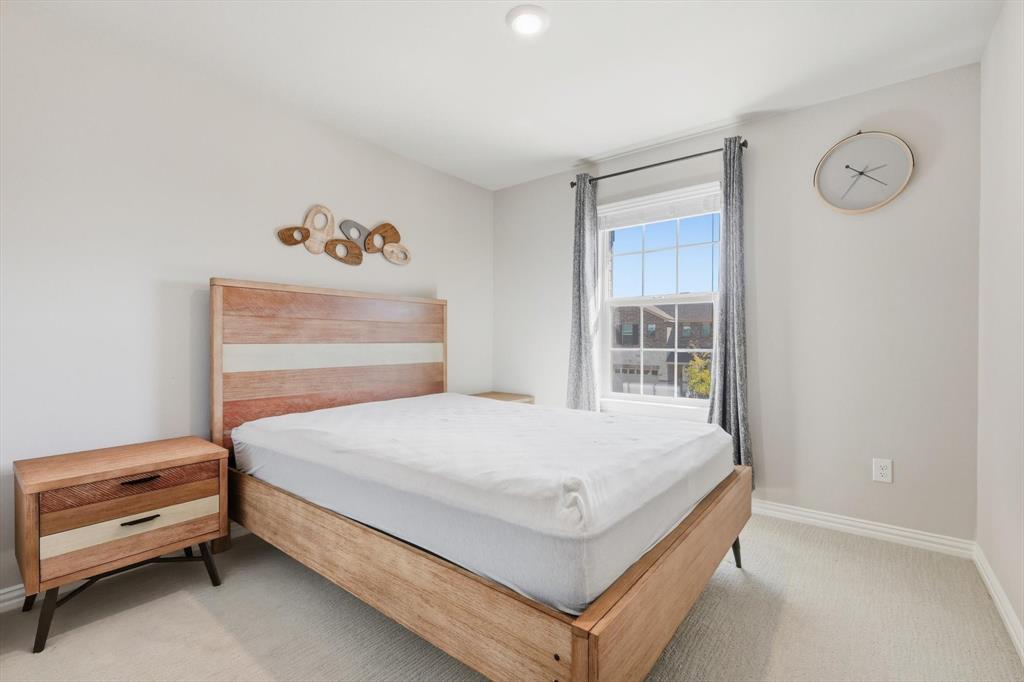 4125 Caprock Canyon Road Sachse, TX 75048 - Photo 24 of 40 a bedroom with a bed and a window