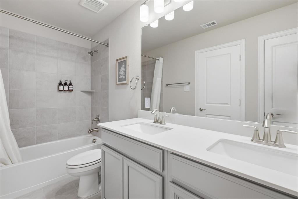 4125 Caprock Canyon Road Sachse, TX 75048 - Photo 26 of 40 a bathroom with a sink a toilet and shower
