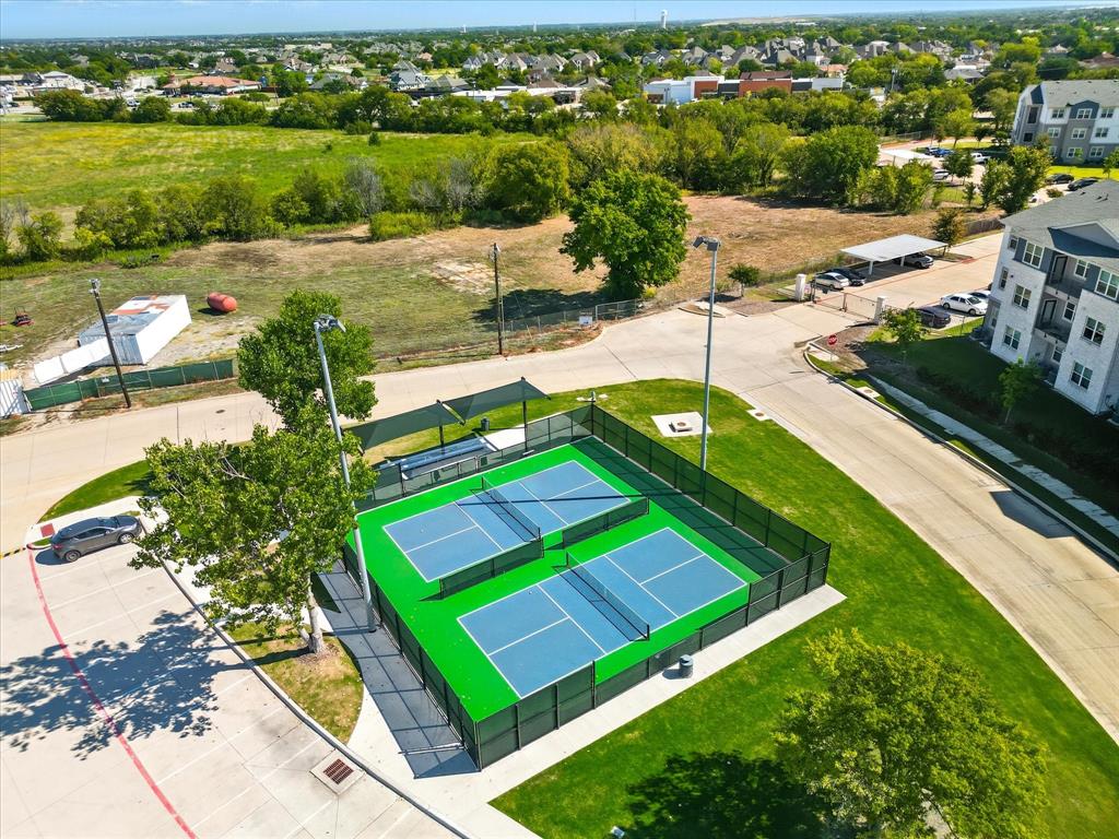4125 Caprock Canyon Road Sachse, TX 75048 - Photo 38 of 40 an aerial view of a house with a garden and lake view