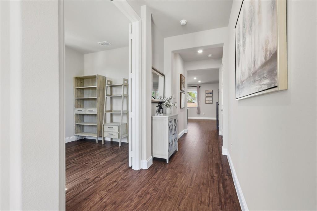4125 Caprock Canyon Road Sachse, TX 75048 - Photo 4 of 40 a view of a hallway with wooden floor and closet