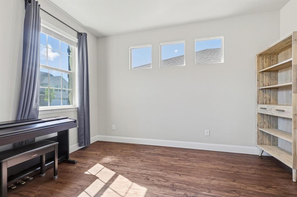 4125 Caprock Canyon Road Sachse, TX 75048 - Photo 5 of 40 a view of an empty room with wooden floor and a window