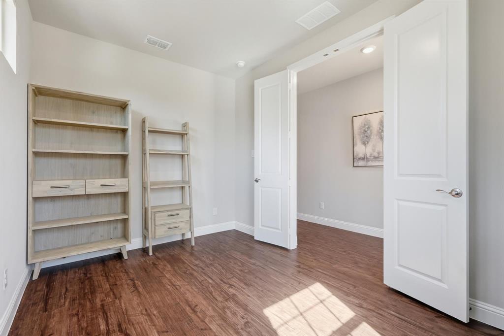 4125 Caprock Canyon Road Sachse, TX 75048 - Photo 6 of 40 a view of walk in closet with wooden floor