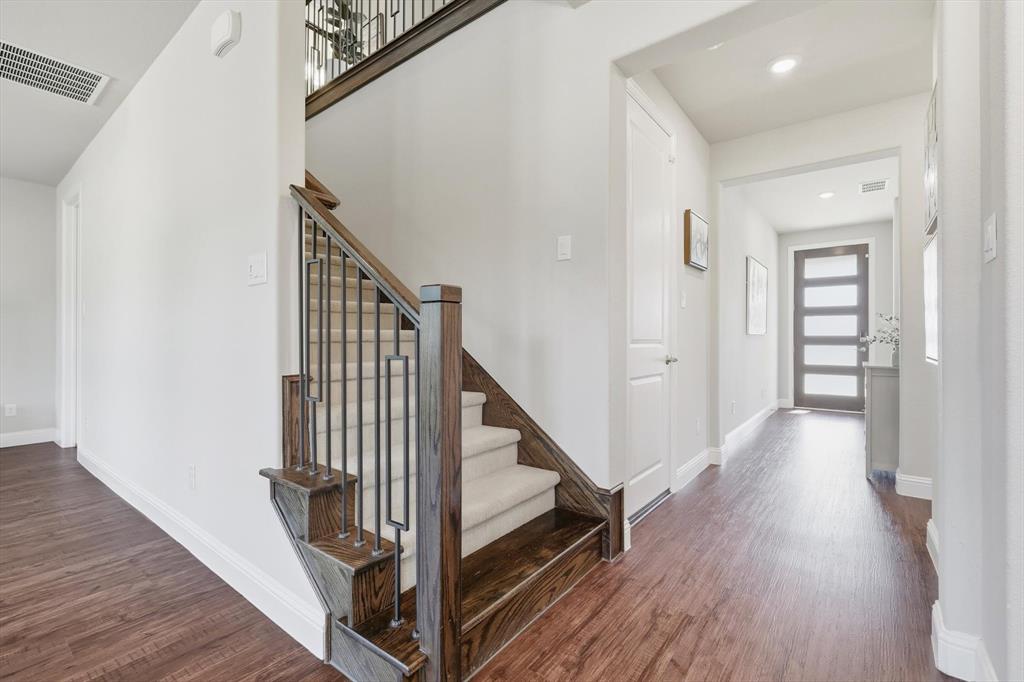 4125 Caprock Canyon Road Sachse, TX 75048 - Photo 8 of 40 a view of a hallway with wooden floor and staircase