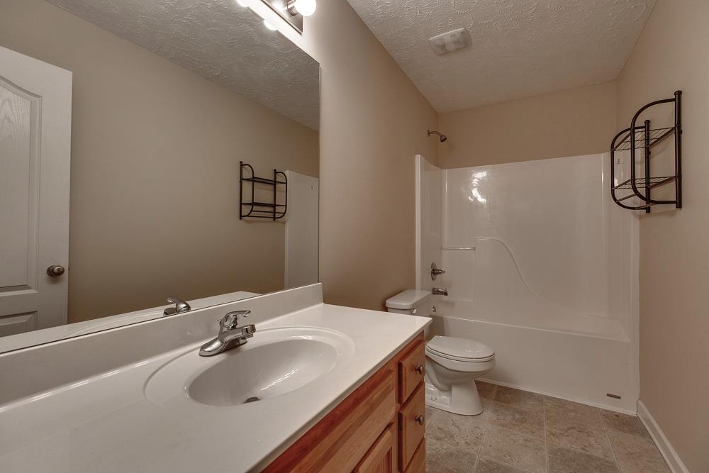 1115 County Line Road Bell Buckle, TN 37020 - Photo 11 of 14 a bathroom with a sink a toilet and shower