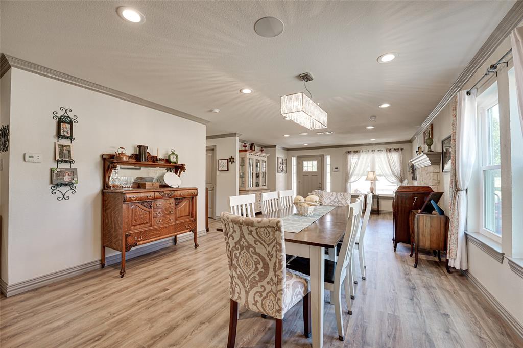 521 Bakers Branch Road Waxahachie, TX 75167 - Photo 12 of 37 Spacious dining area featuring wood-finish flooring, recessed lighting, and a linear crystal chandelier