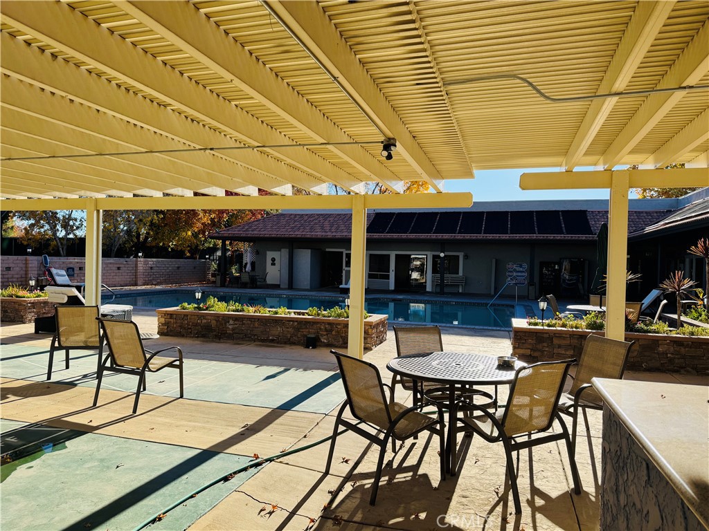 13393 Mariposa Road, Unit 281 Victorville, CA 92395 - Photo 4 of 16 a view of a patio with a table and chairs