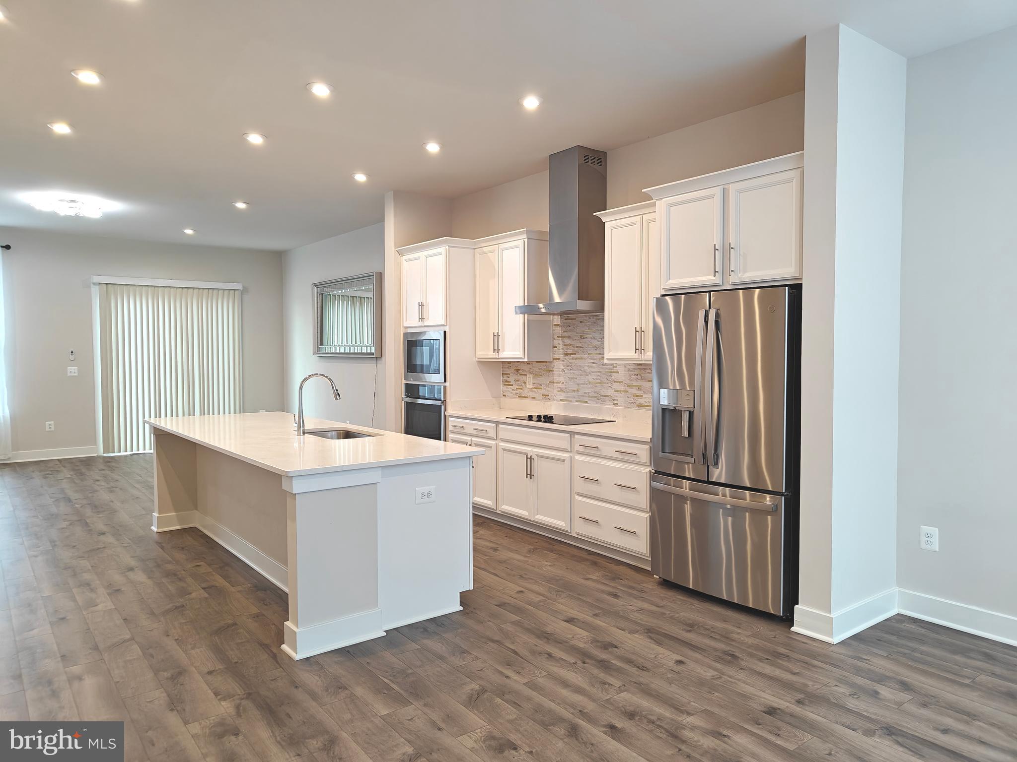 2393 Liberty Loop Herndon, VA 20171 - Photo 13 of 45 a kitchen with white cabinets and stainless steel appliances