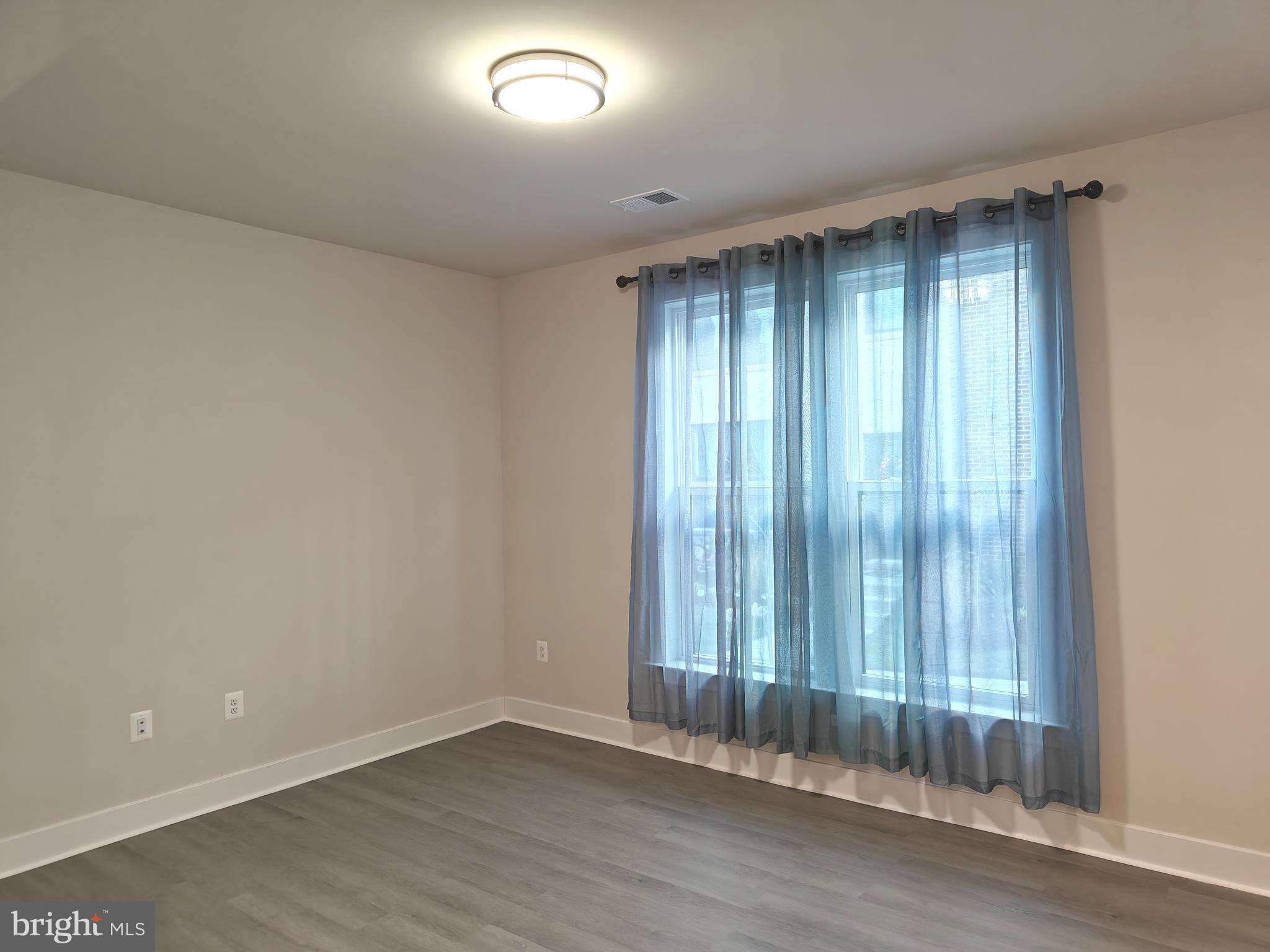 2393 Liberty Loop Herndon, VA 20171 - Photo 30 of 45 an empty room with wooden floor and windows