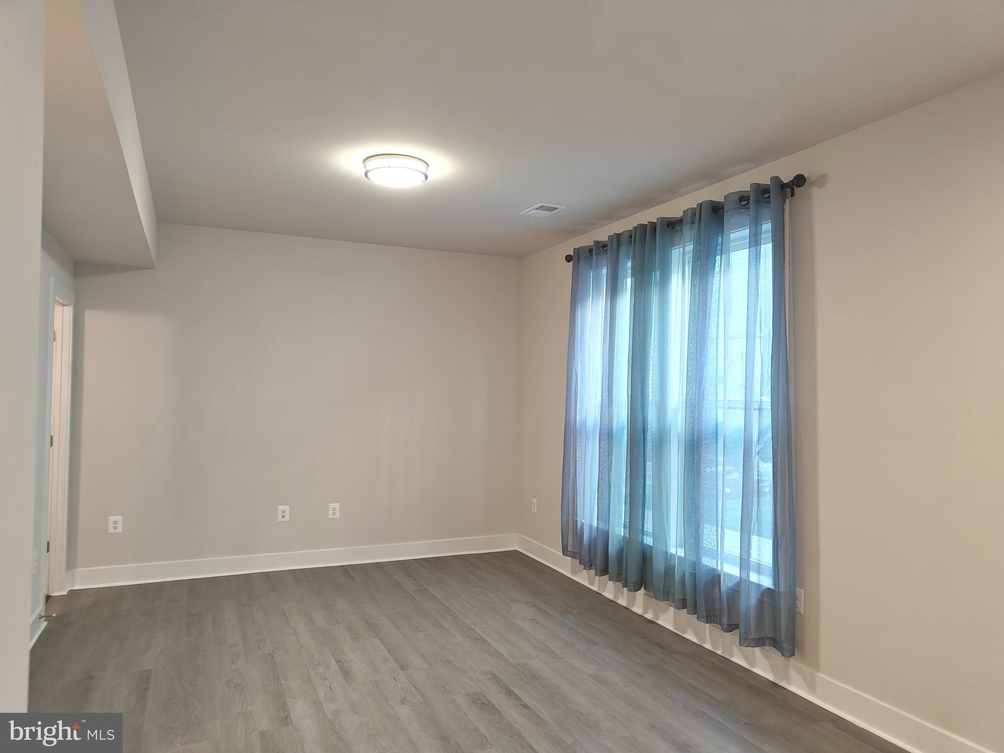 2393 Liberty Loop Herndon, VA 20171 - Photo 33 of 45 an empty room with wooden floor and windows