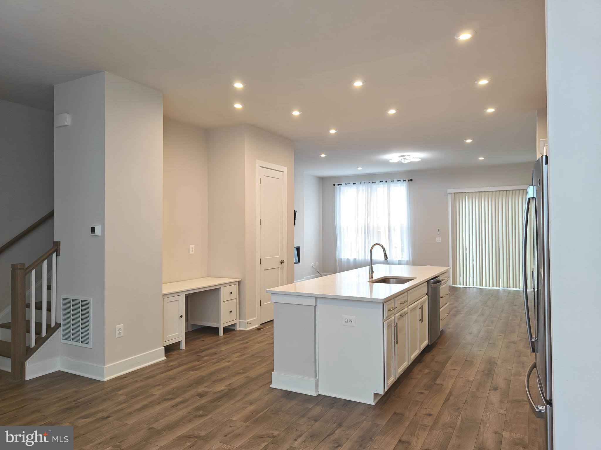 2393 Liberty Loop Herndon, VA 20171 - Photo 6 of 45 a kitchen with center island and stainless steel appliances