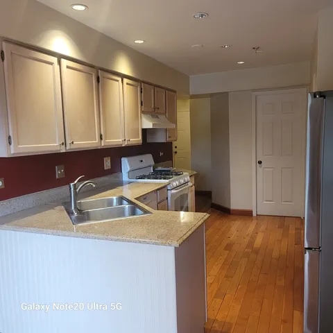 a kitchen with a sink a stove and cabinets