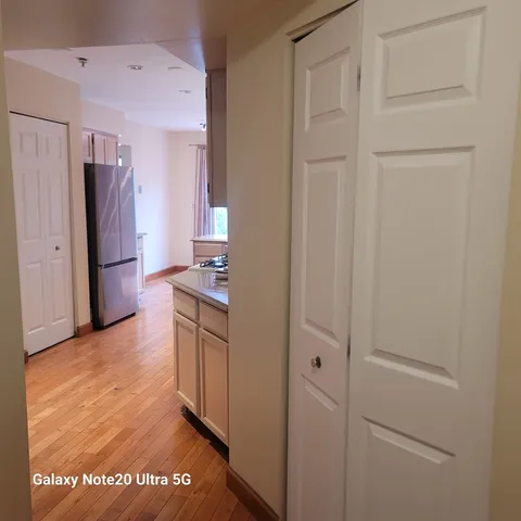 a kitchen with cabinets and a refrigerator