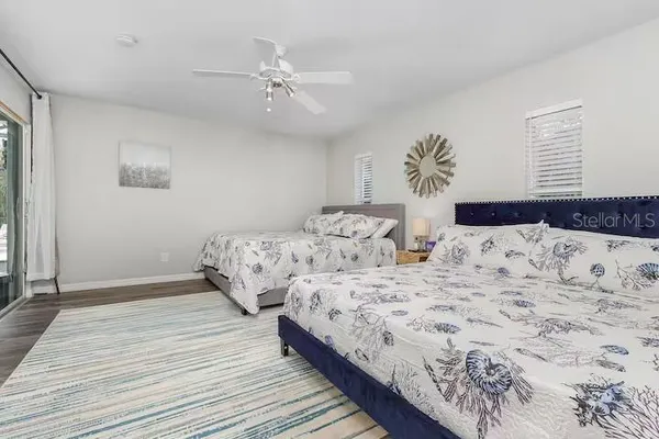 a bedroom with double bed and a chandelier