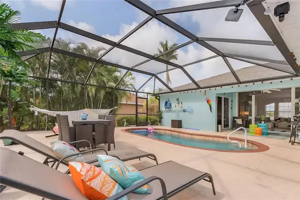 an aerial view of a house with a swimming pool yard and outdoor seating