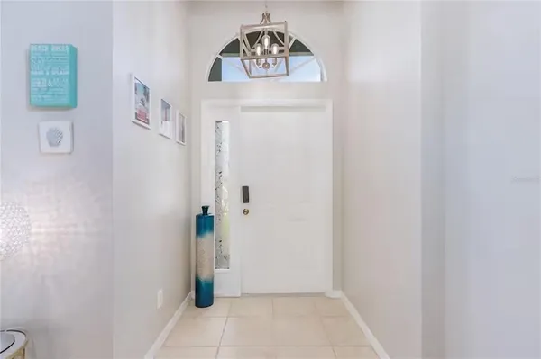 a living room with furniture a fireplace and a chandelier