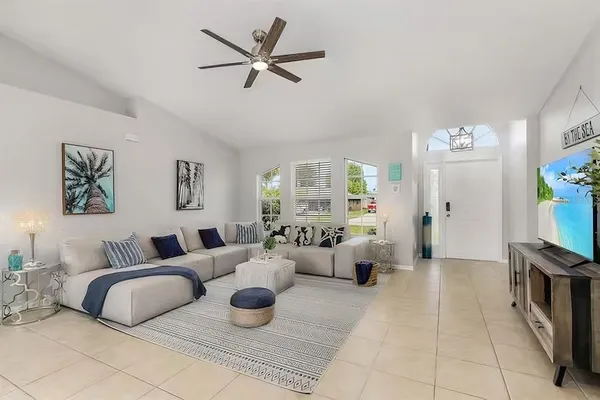 a living room with furniture and a large window