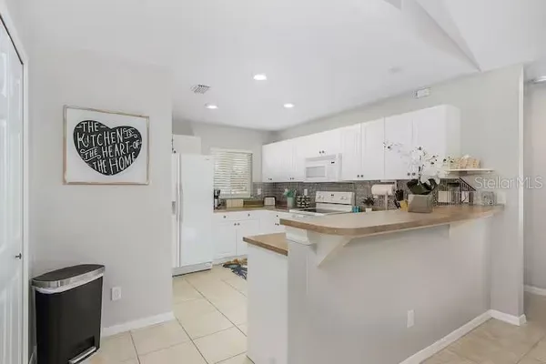 a kitchen with appliances cabinets and a counter top space