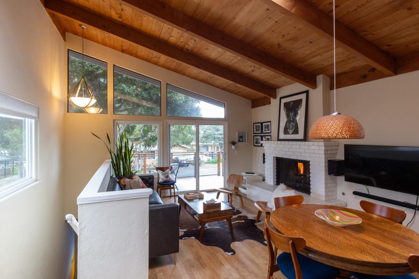 779 Alice Street Monterey, CA 93940 - Photo 7 of 27 a living room with furniture a fireplace and a floor to ceiling window