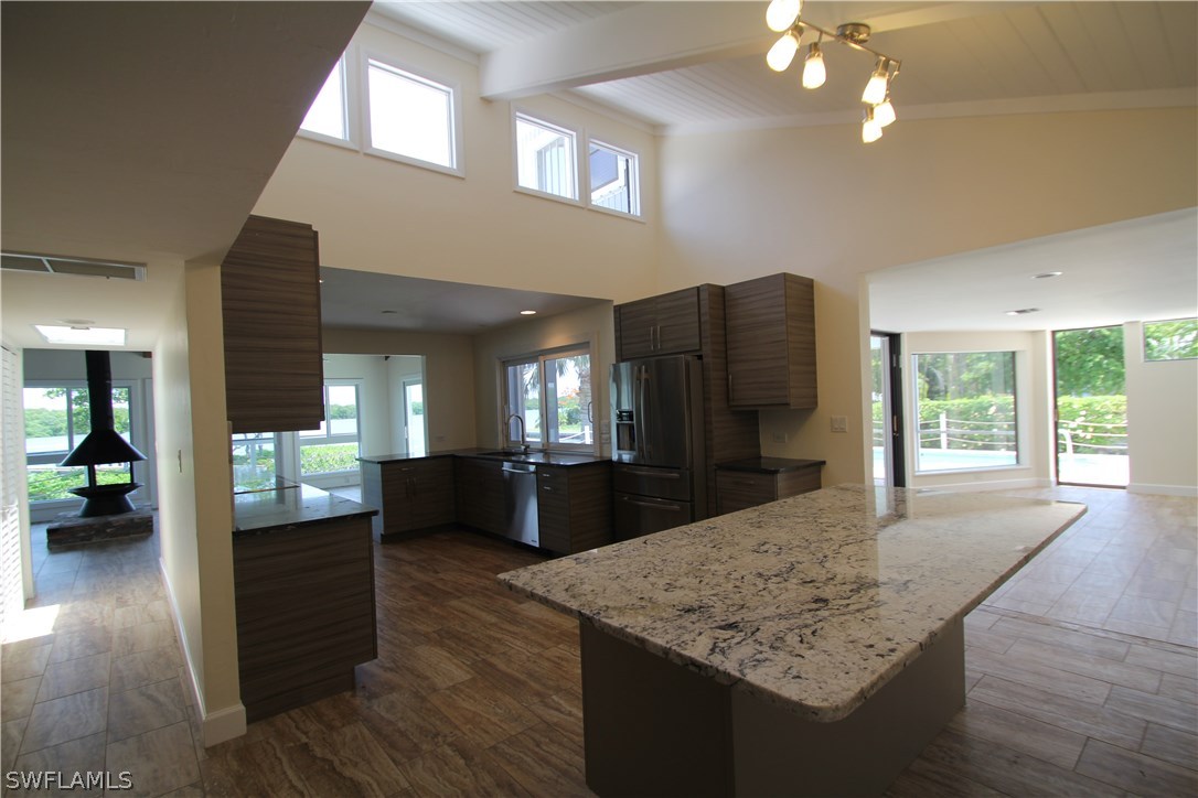 21521 Madera Road Fort Myers Beach, FL 33931 - Photo 16 of 24 a view of kitchen with cabinets and wooden floor