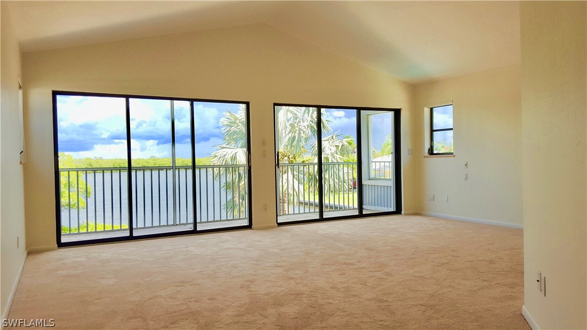 21521 Madera Road Fort Myers Beach, FL 33931 - Photo 9 of 24 a view of an empty room with a balcony