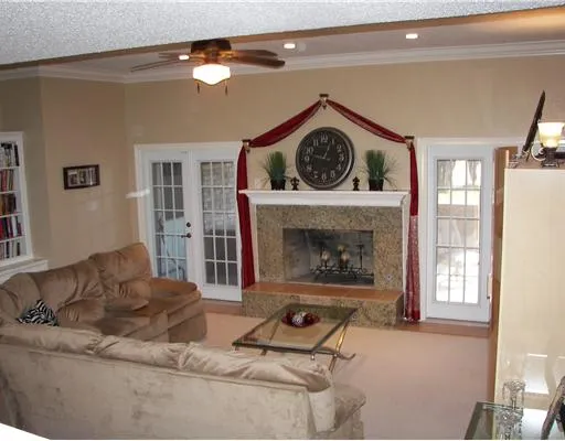 a living room with furniture and a fireplace