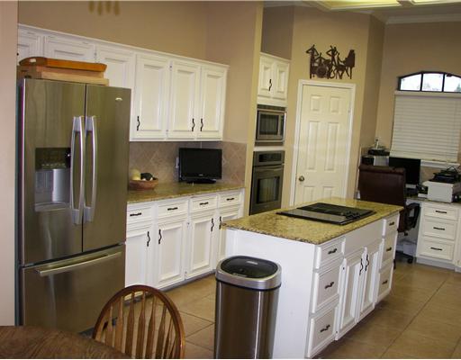 7006 Brandon Drive Corpus Christi, TX 78413 - Photo 4 of 8 a kitchen with stainless steel appliances granite countertop a refrigerator stove and sink