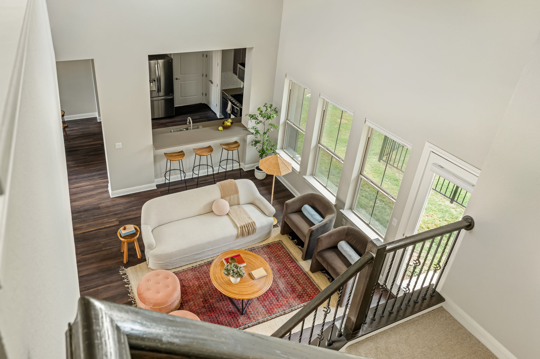 2516 Hopsack Mills Road Austin, TX 78748 - Photo 22 of 39 Bright living area featuring high ceilings, dark wood-finish flooring, and a wrought iron staircase