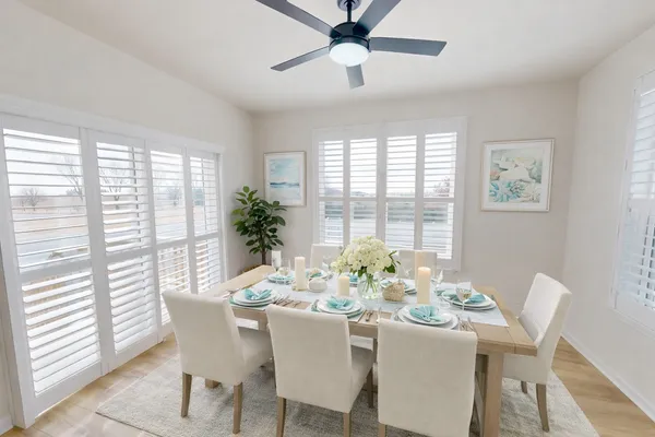 a dining room with furniture a chandelier and wooden floor