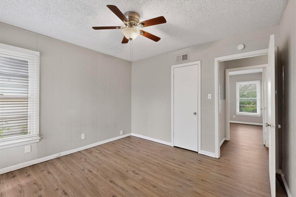 4508 Rutland Avenue Fort Worth, TX 76133 - Photo 27 of 36 an empty room with wooden floor and windows