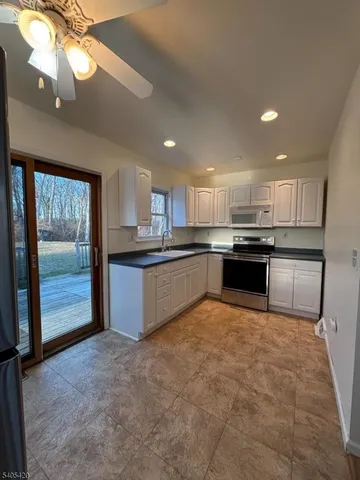 a large kitchen with cabinets and stainless steel appliances