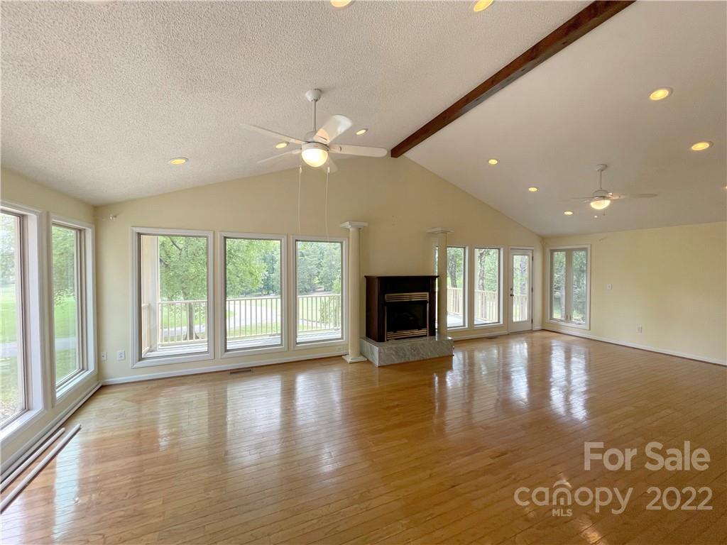 4039 Rounding Run Road Charlotte, NC 28277 - Photo 5 of 28 a view of an empty room with wooden floor and a window