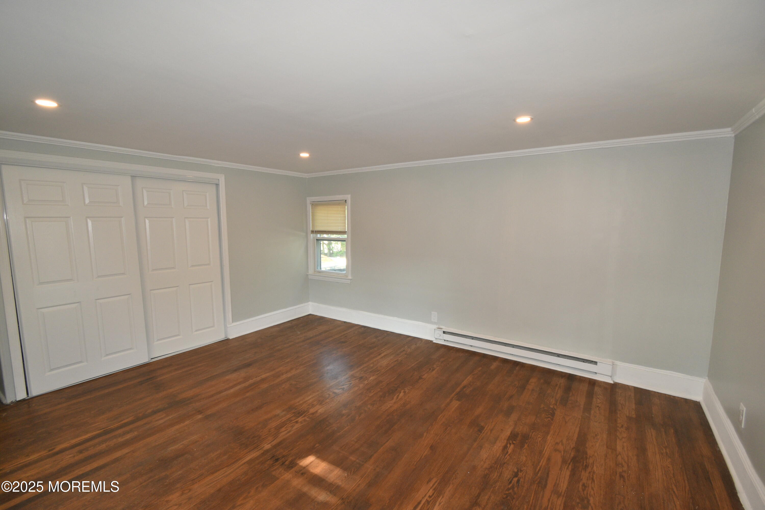 164 Front, Unit 2 Keyport, NJ 07735 - Photo 3 of 11 a view of an empty room with wooden floor and a window