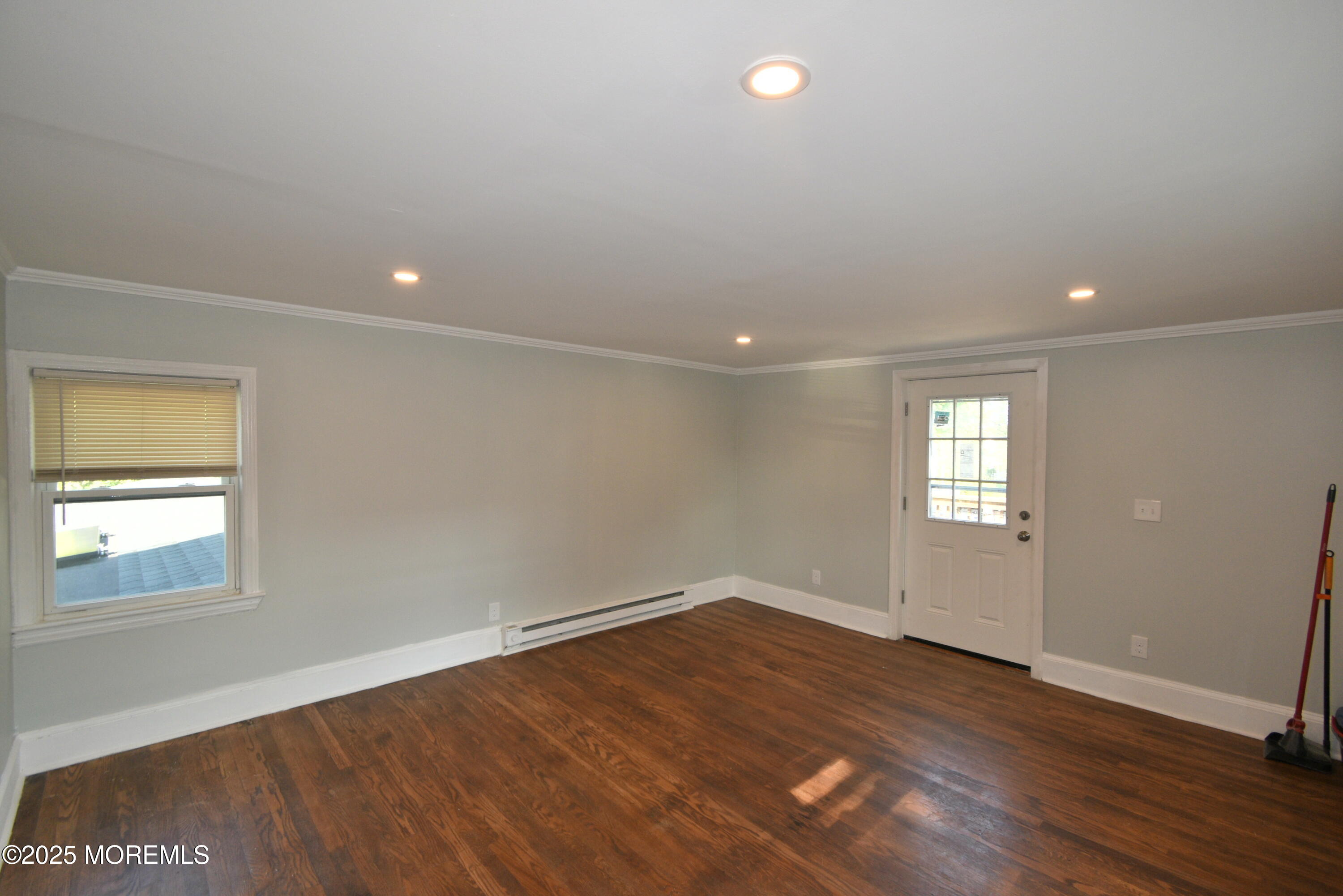 164 Front, Unit 2 Keyport, NJ 07735 - Photo 4 of 11 an empty room with wooden floor and windows