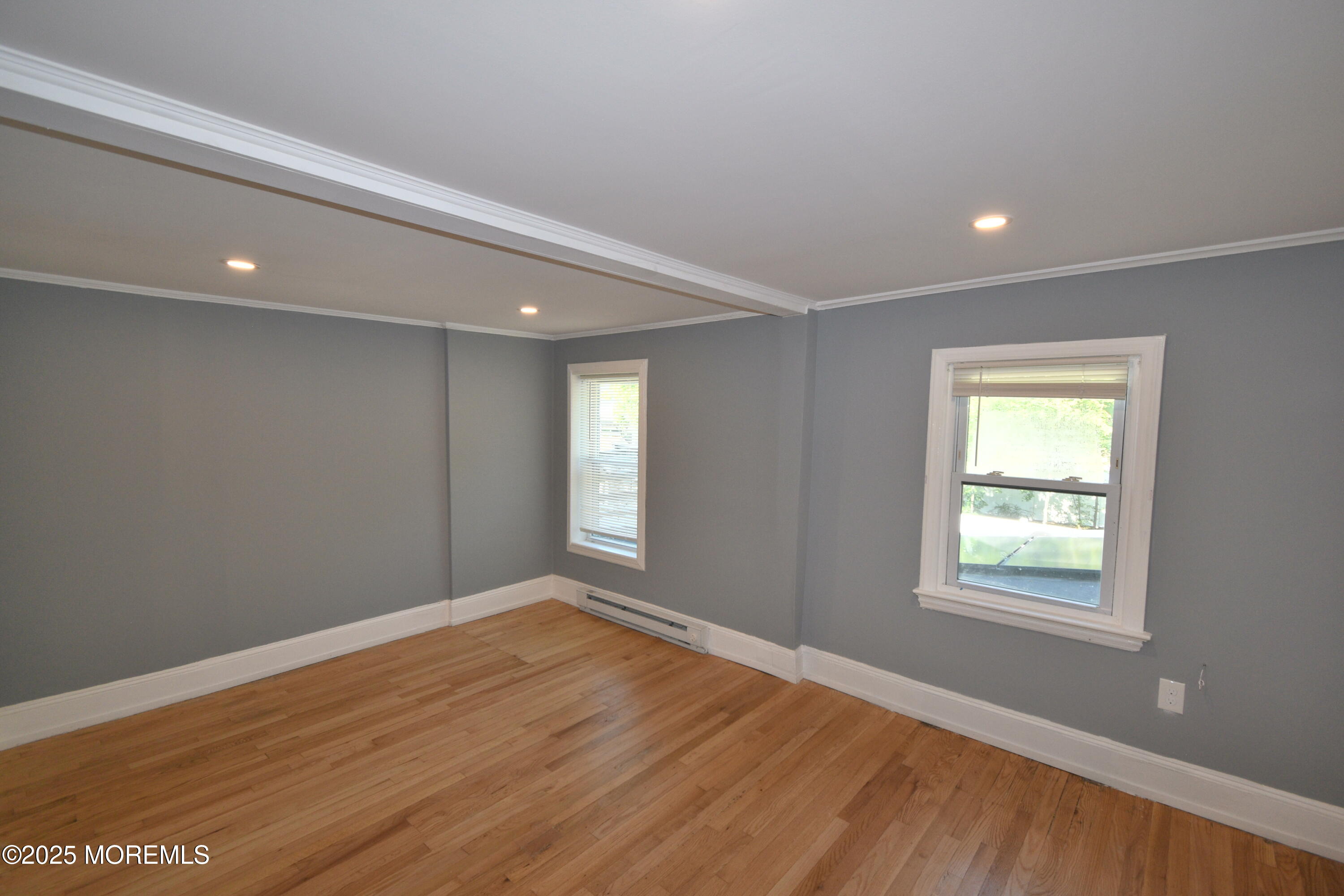 164 Front, Unit 2 Keyport, NJ 07735 - Photo 5 of 11 a view of an empty room with wooden floor and a window