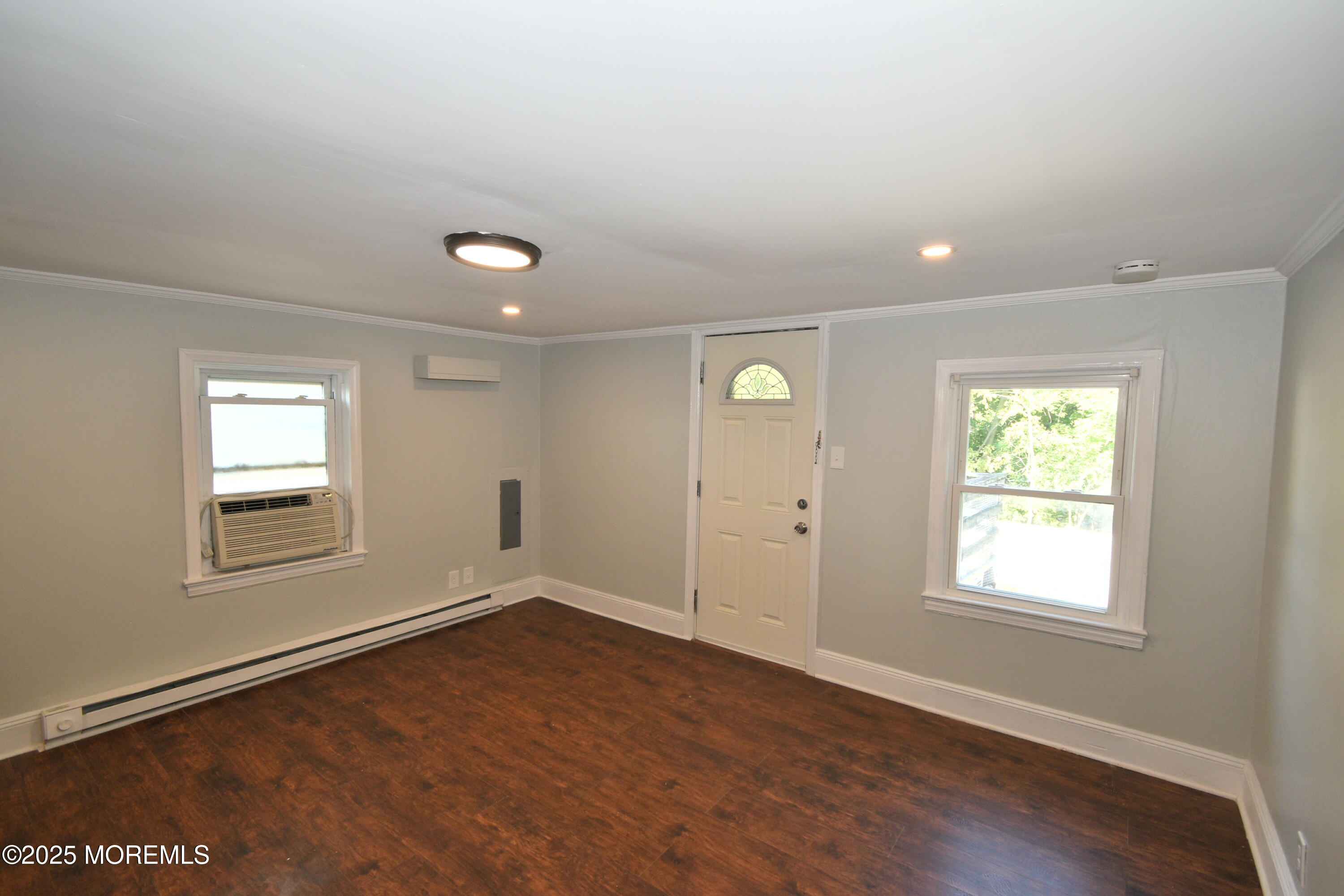 164 Front, Unit 2 Keyport, NJ 07735 - Photo 7 of 11 an empty room with wooden floor and windows