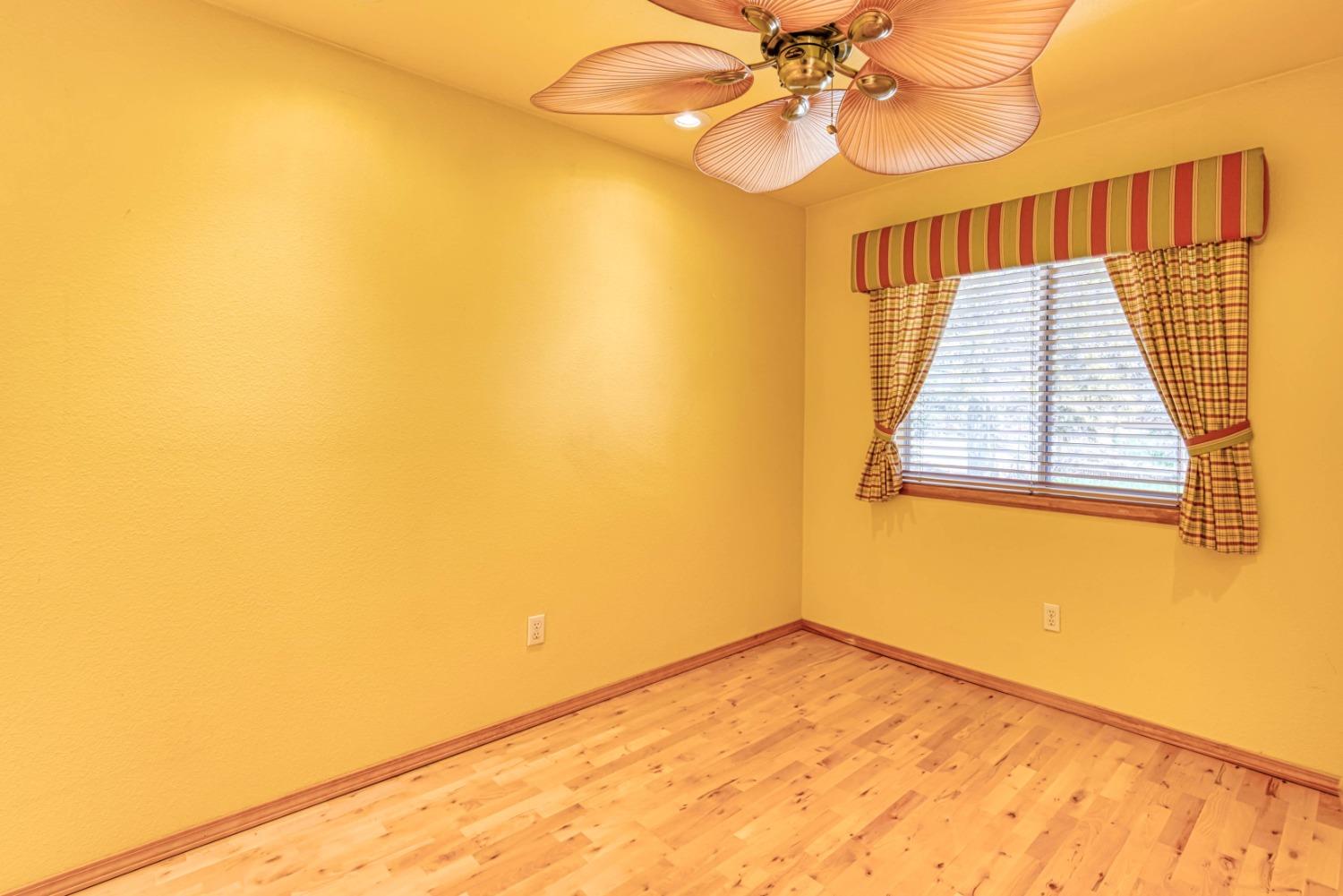 34201 Natoma Road Auberry, CA 93602 - Photo 12 of 40 a view of an empty room with wooden floor and a window
