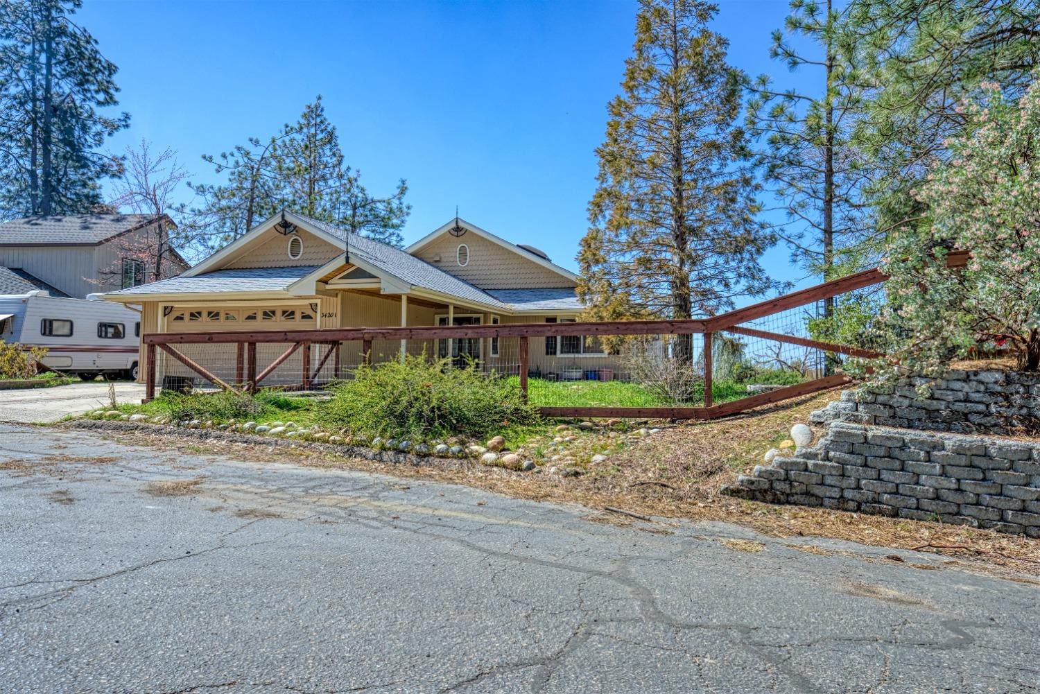 34201 Natoma Road Auberry, CA 93602 - Photo 3 of 40 a front view of a house with a yard and potted plants