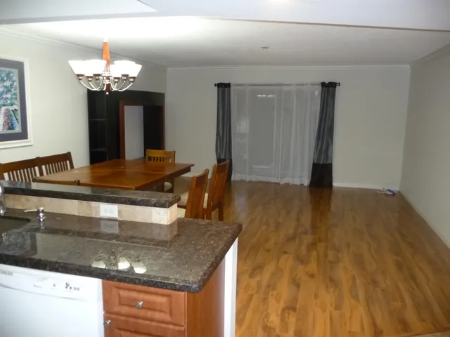 a kitchen with kitchen island a counter top space a sink and appliances