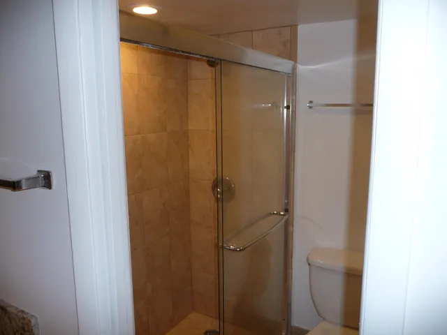 a bathroom with a glass shower door