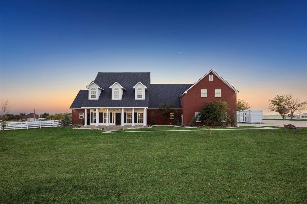 a view of a house with a big yard and large trees