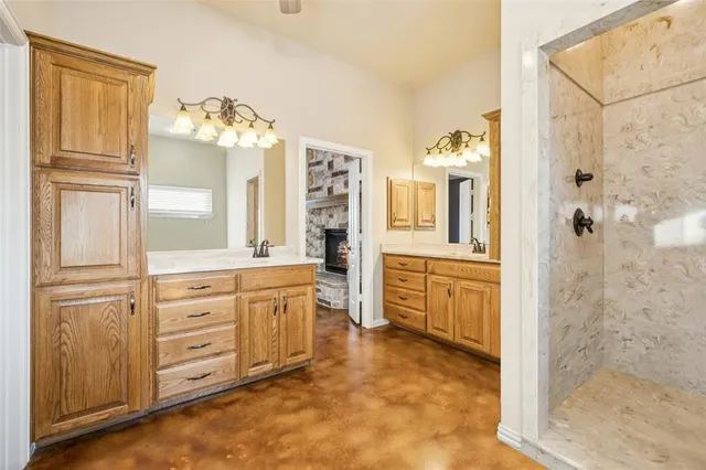 a bathroom with a granite countertop sink mirror and a bathtub