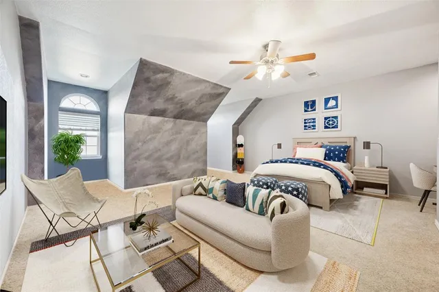 a bedroom with a large bed couch and a window